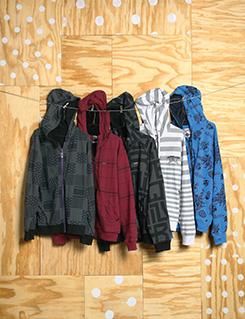 hoodies on plywood wall